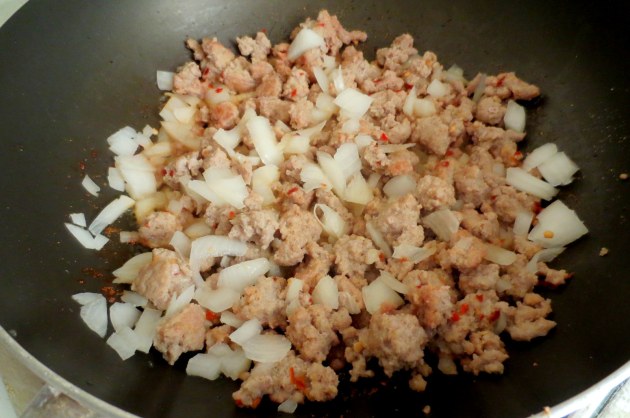 Cook until no longer pink and throw in the onions. Cook until the onions are soft.